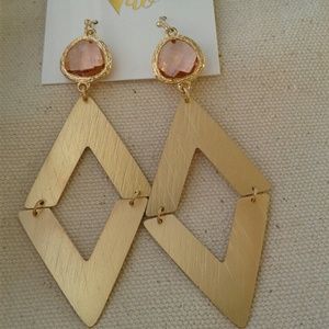 Brushed gold tone dangle earrings with pink stones